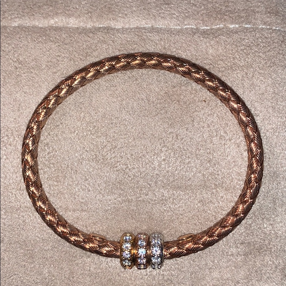Gold tone woven bracelet w 3 bands of rhinestones